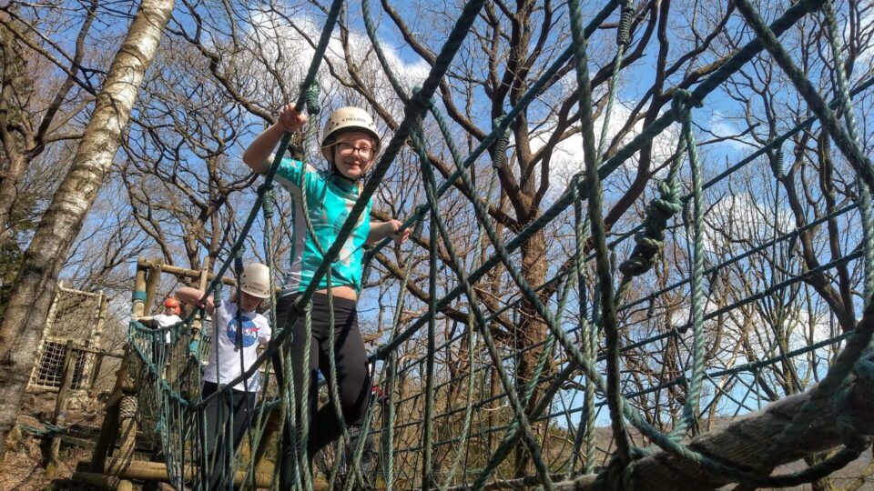 Child on ropes at day camp